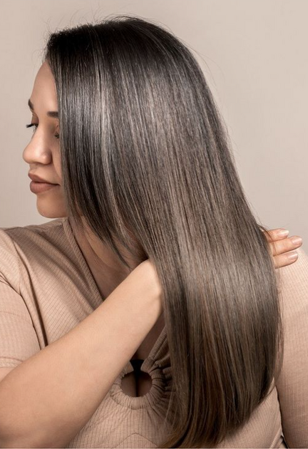 Woman receiving professional keratin, smoothening, or botox hair treatment at VLCC Wakad salon